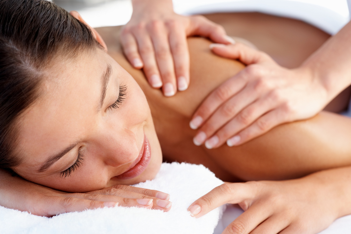 Masseuse Massaging Woman's Shoulder